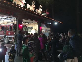 Image used for holiday caroling promotion, group at firehouse